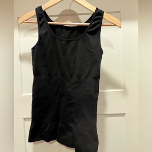 Really tight tank designed to suck everything in.